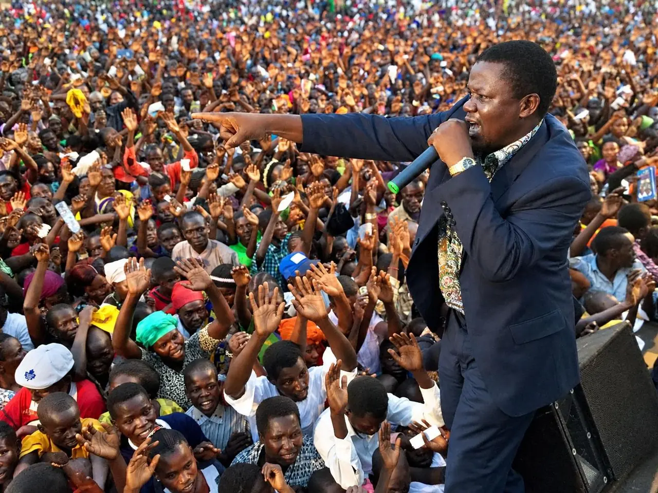 Preaching to a crowd raising their hands in response